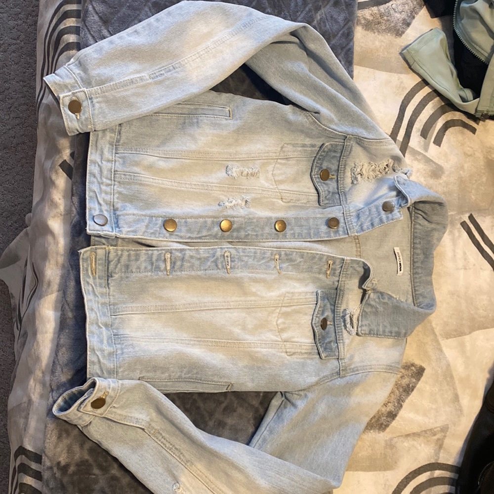 Light wash distressed denim jacket